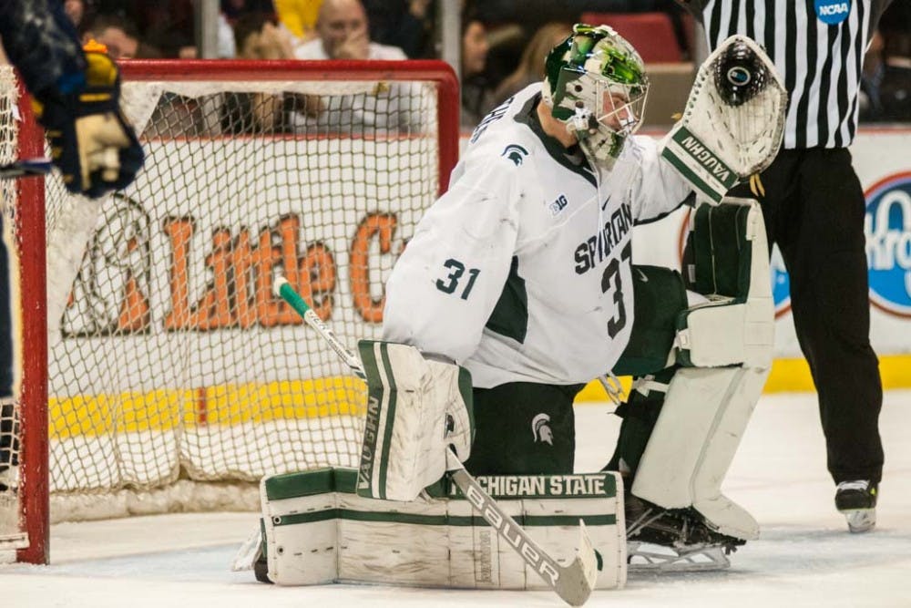 Freshman goaltender John Lethemon (31) catches the puck during the third period of the men?s hockey game against the University of Michigan on Feb. 10, 2017 at Joe Louis Arena in Detroit. The Spartans were defeated by the Wolverines in an overtime shootout, 5-4. 