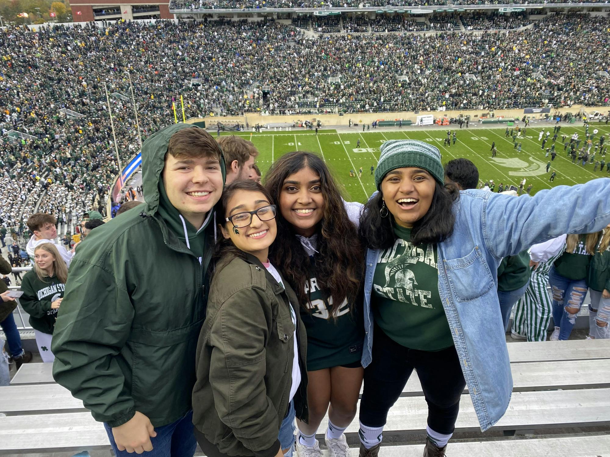 <p>Physiology senior Grant Zydeck, physiology senior Yamini Pandey, computational data science senior Abirami Varatharajan and kinesiology senior Parita Shah during the Michigan State vs. University of Michigan football at the Spartan Stadium on Oct. 30, 2021. Courtesy of Grant Zydeck.</p>