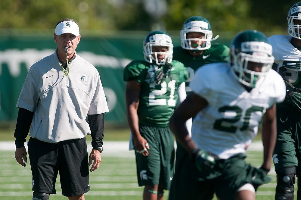 	<p>Head coach Mark Dantonio watches practice Aug. 9, 2013, at the practice field outside Duffy Daugherty Football Building. Julia Nagy/The State News</p>