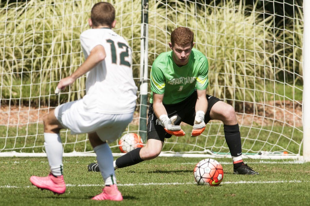 <p>Senior goalkeeper Zachary Bennett reaches down for a save during the game against Creighton on Sept. 13, 2015 at the DeMartin Soccer Stadium. Bennett recently became the most successful goalkeeper in MSU history. Catherine Ferland/The State News</p>