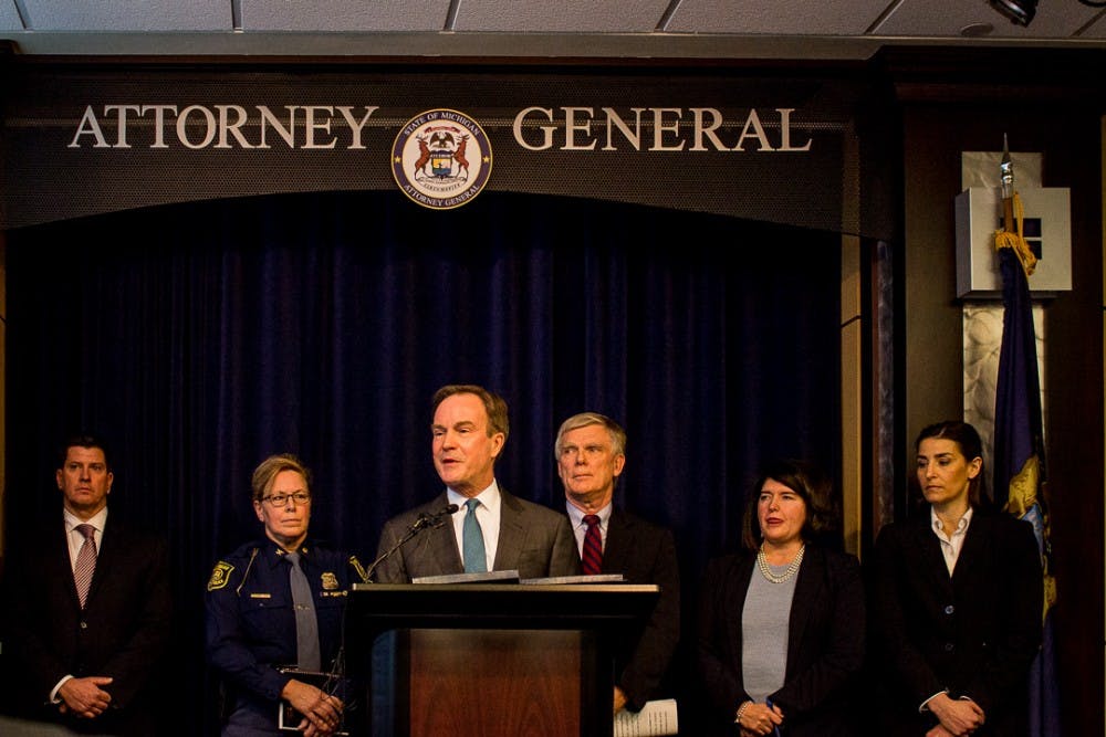 Michigan Attorney General Bill Schuette surrounded by his investigation team speaks to the media about the investigation into MSU on Jan 27, 2018 at 525 W. Ottawa in Lansing. "At the end of this investigation, it will be public, it will be transparent..," Schuette said. "We will put a bright light on the university. This will be done right, period." 