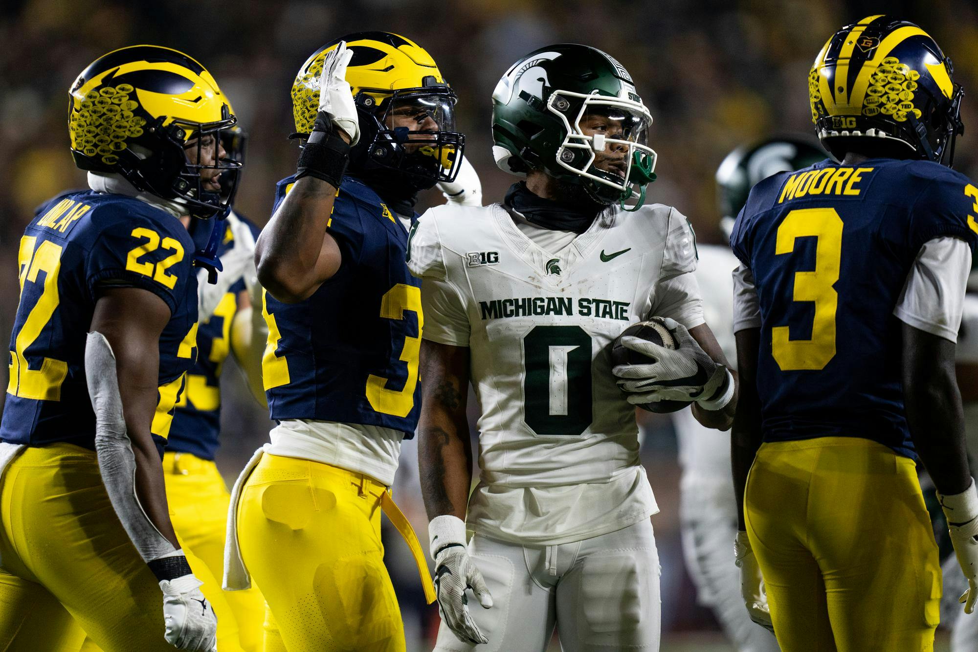 <p>University of Michigan players antagonize Michigan State redshirt senior Alante Brown (0) after receiving a kick-off at Michigan Stadium on Oct. 26, 2024. Penalties cost the Spartans their chance at the Paul Bunyon trophy this year as they fell 24-17 to the rival Wolverines.</p>