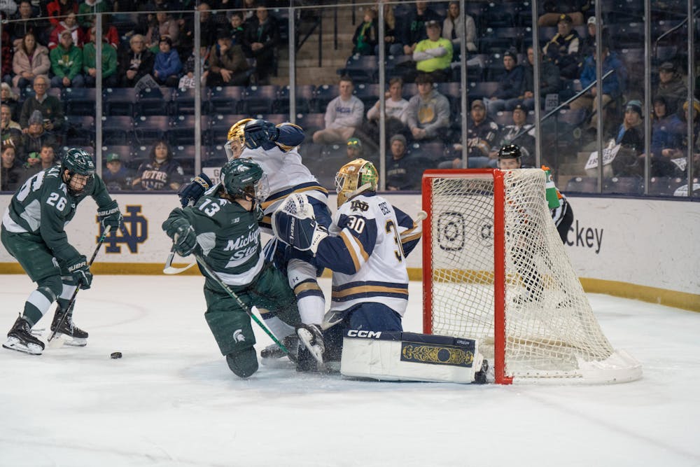 <p>MSU sophomore forward Tanner Kelly looks to shoot through a tangle of bodies in front of the net at Compton Family Ice Arena in Notre Dame, IN on Friday, March 3, 2023. MSU recorded 36 unsuccessful shots as they fell 1-0 to Notre Dame.</p>