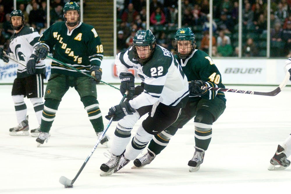 Sophomore forward Lee Reimer leads the puck pass Northern Michigan forward Stephan Vigier. The Michigan State Spartans defeated the Northern Michigan Wildcats, 2-1, Saturday night at Munn Ice Arena. Justin Wan/The State News