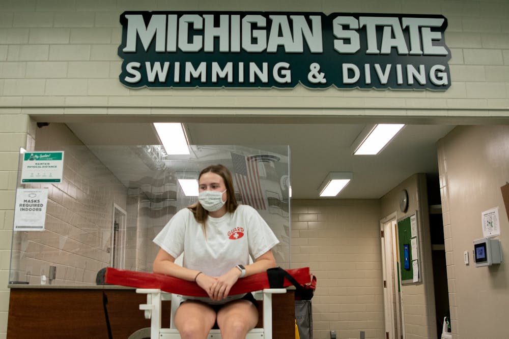 <p>Junior Sophia Balow watches the waters at the IM West pool, where she used to swim as a Spartan, on Oct. 21, 2021; one day before the year anniversary of the team being cut from Michigan State Athletics.</p>