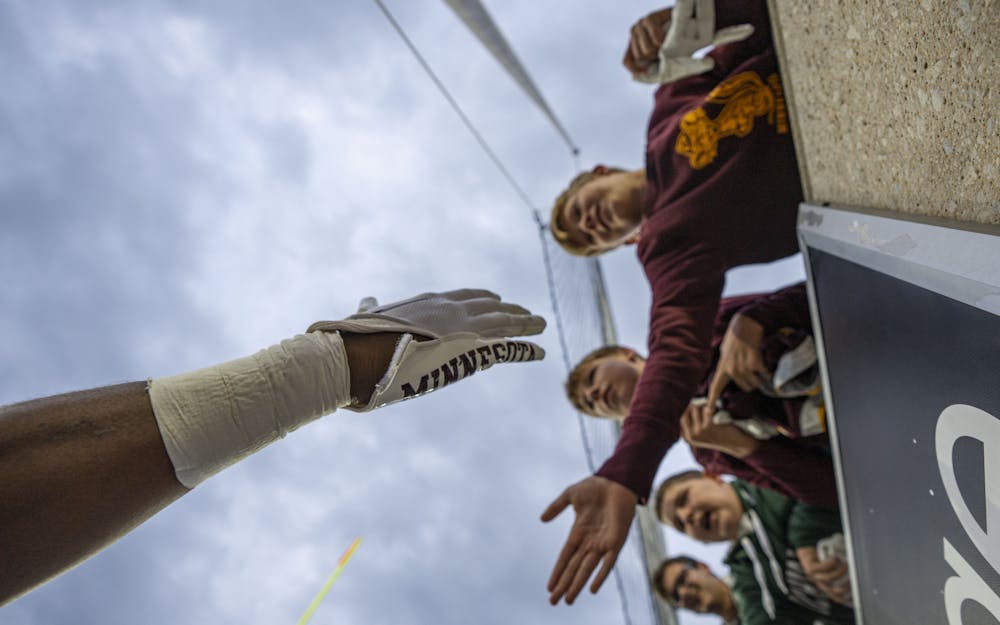 <p>Minnesota players high-five fans after their 34-7 win over Michigan State on Saturday, Sept. 24, 2022 at Spartan Stadium. </p>