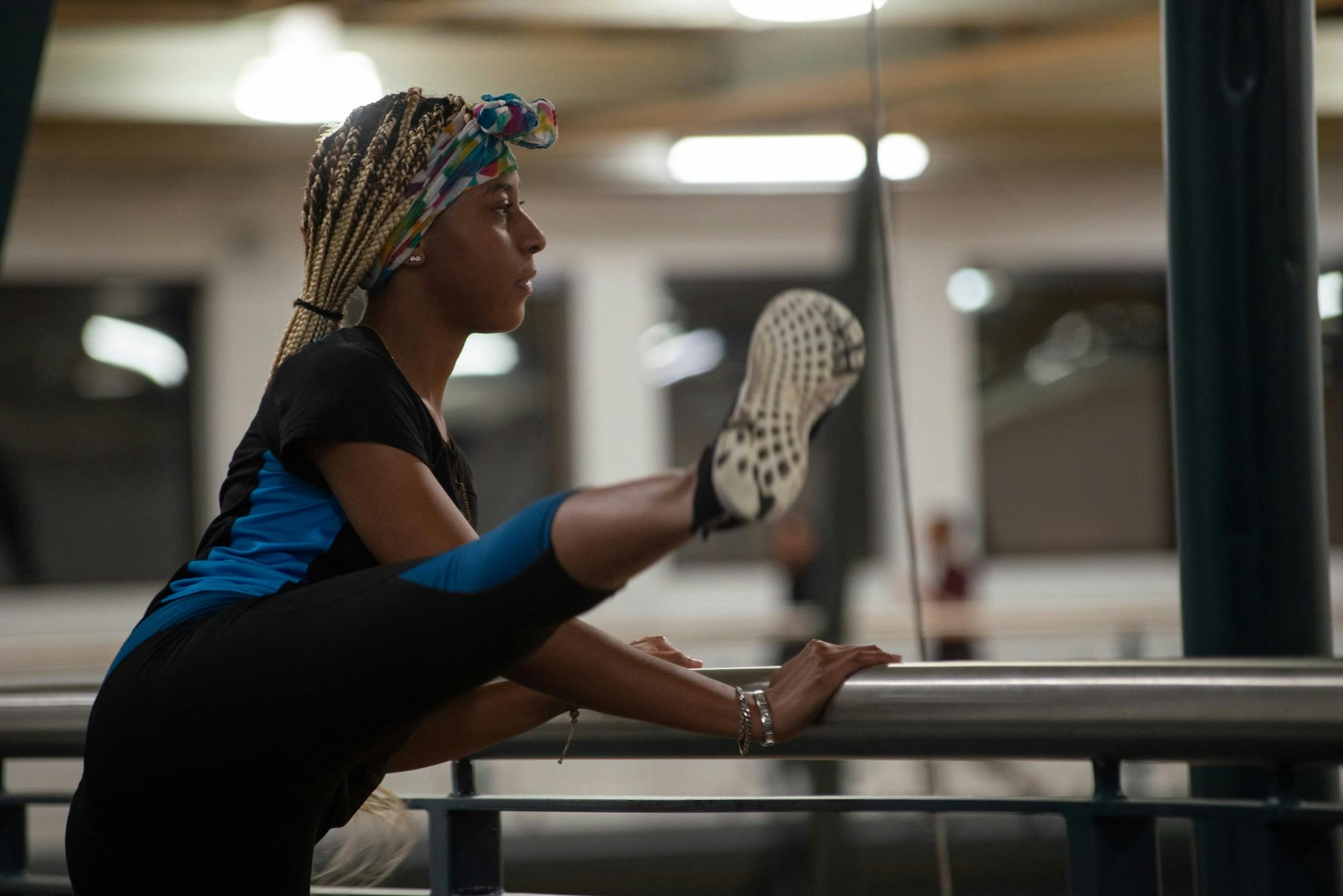 <p>President of BGF, Jasmine Parker, stretches after warming up on the indoor track on Feb. 3, 2020 at IM Sports East.</p>