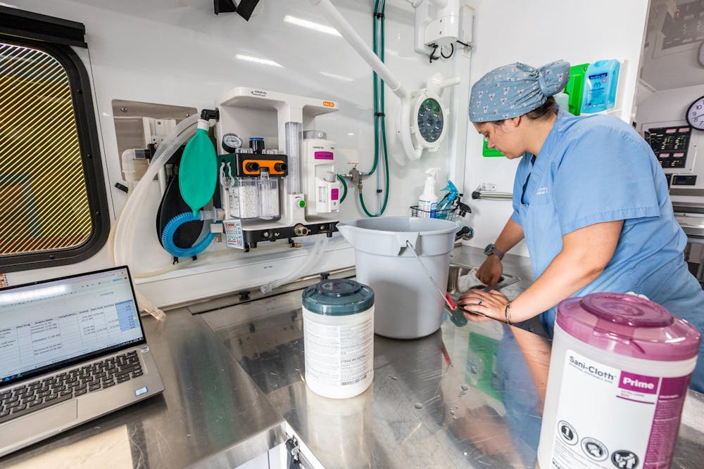 MSU Licensed Veterinary Technician Rebecca Wood cleans up the MSU Veterinary Mobile Unit after performing many procedures in Warren, Mich., on July 16, 2026.
