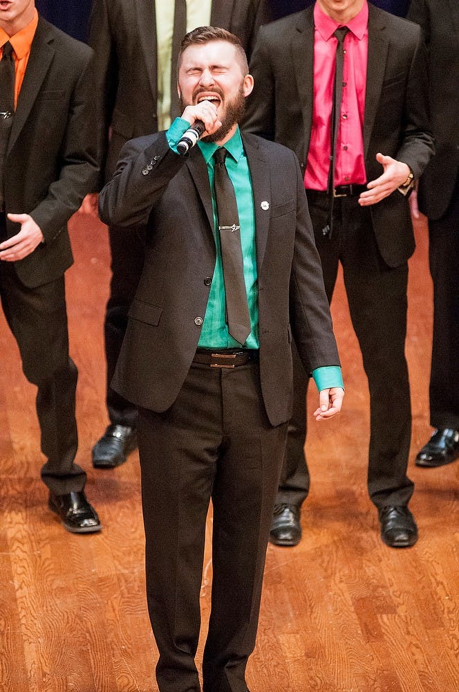 <p>Political science senior Connor Ralph takes the lead during the Accafellas' performance at the International Championship of Collegiate A Cappella Great Lakes Quarterfinal Feb. 7, 2015, at Wharton Center. The group placed second advancing them to the semifinal held Mar. 21, 2015, in Dayton, Ohio. Kelsey Feldpausch/The State News</p>