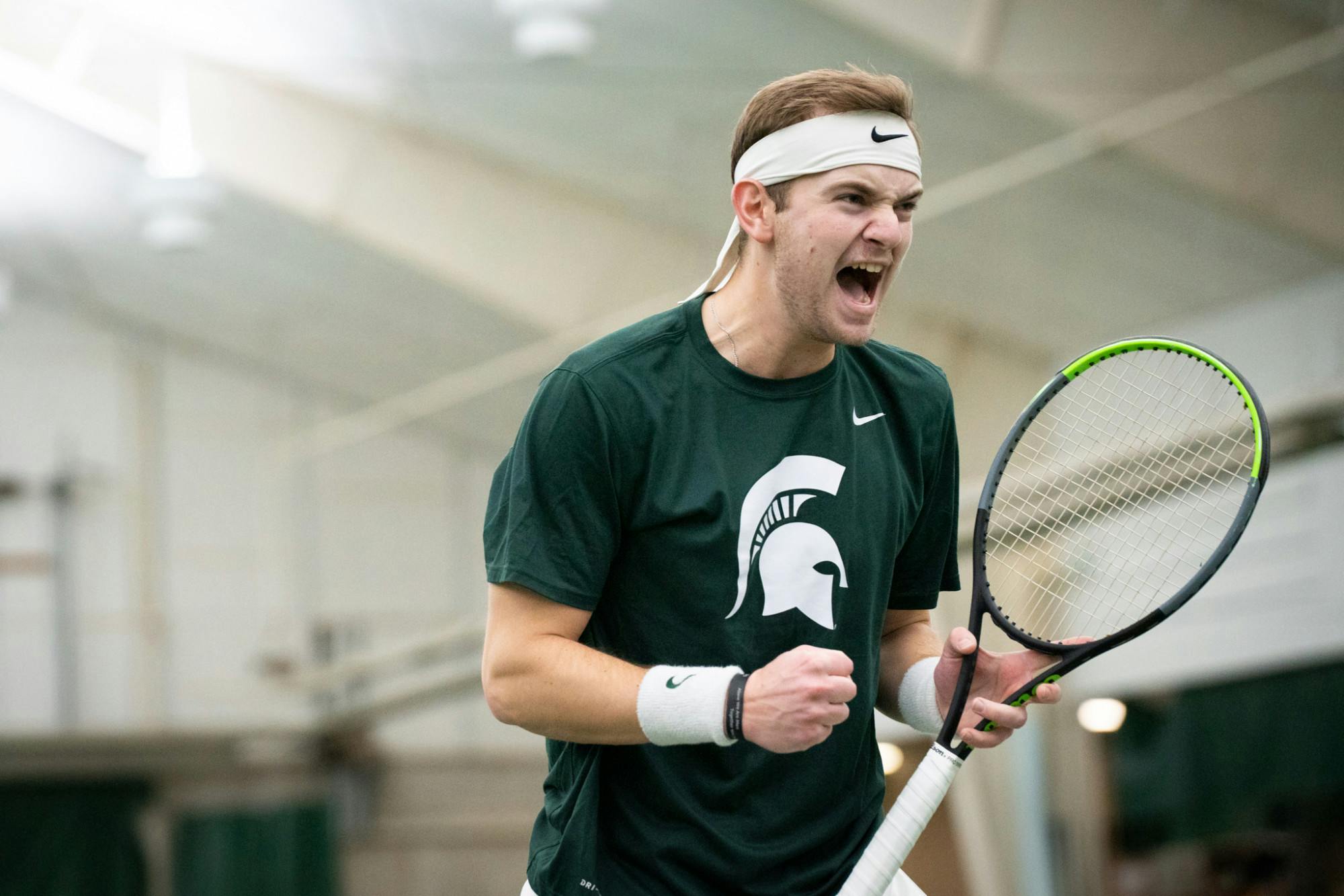 <p>Redshirt senior Jack Winkler celebrates after winning a point against Louisville’s junior Etienne Donnet on Feb. 12, 2022.</p>