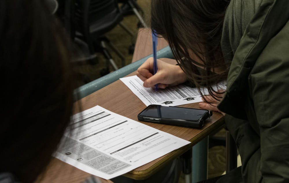 A student fills out an absentee ballot during the UAB hosted AbsenTEA Party on Feb. 11, 2020.