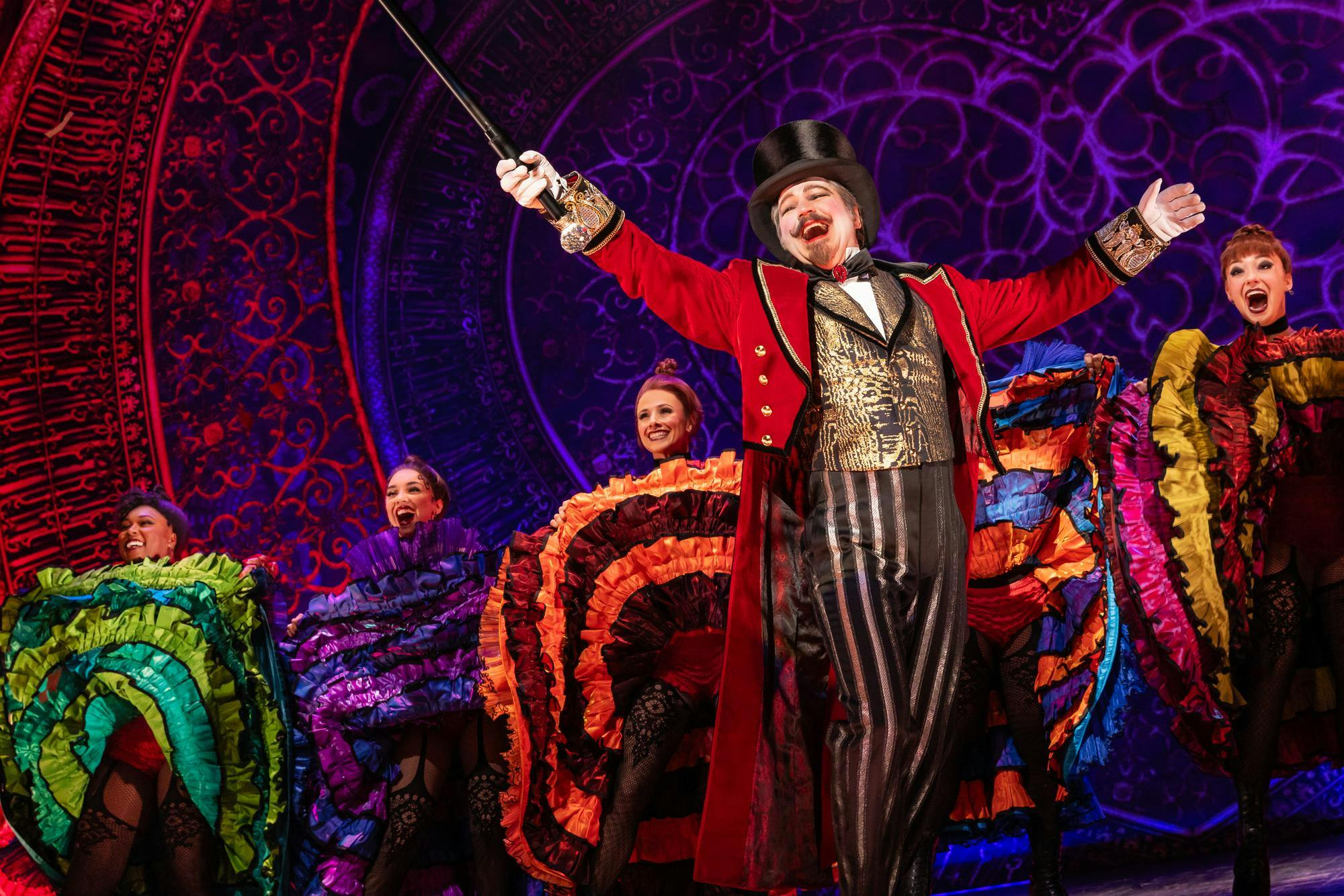 <p>Harold Zidler, played by Robert Petkoff, and characters played by the North American cast of "Moulin Rouge! The Musical." Photo courtesy of Matthew Murray.</p>