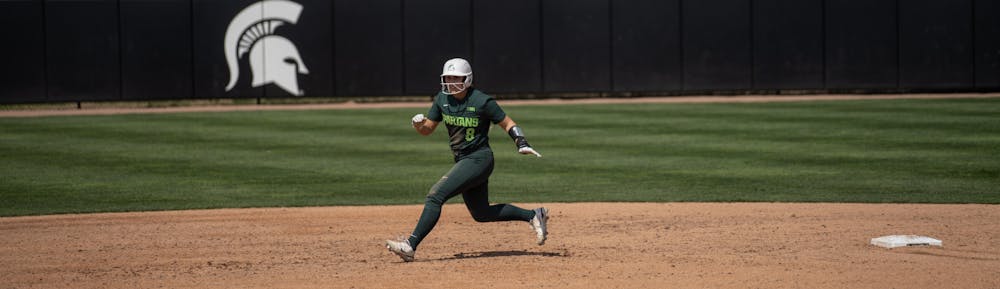 <p>Spartan Brooke Snyder rounds second and heads for third base during her game against the Minnesota Golden Gophers on April 15, 2023.</p>