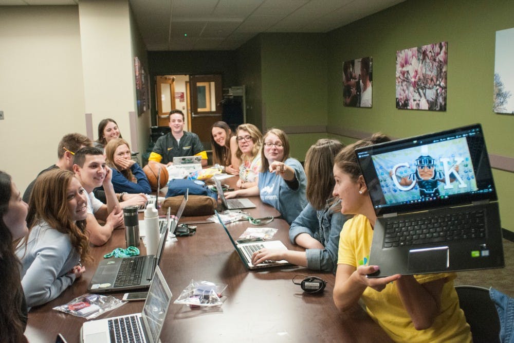 <p>Coordinators react as communications senior Anastasia Monsell shows them a photo during the Camp Kesem Coordinator Meeting on April 24, 2017 at Erickson Hall. Camp Kesem is an annual summer camp put on by MSU students for individuals ages 7-17 whose parents have been affected by cancer.&nbsp;</p>