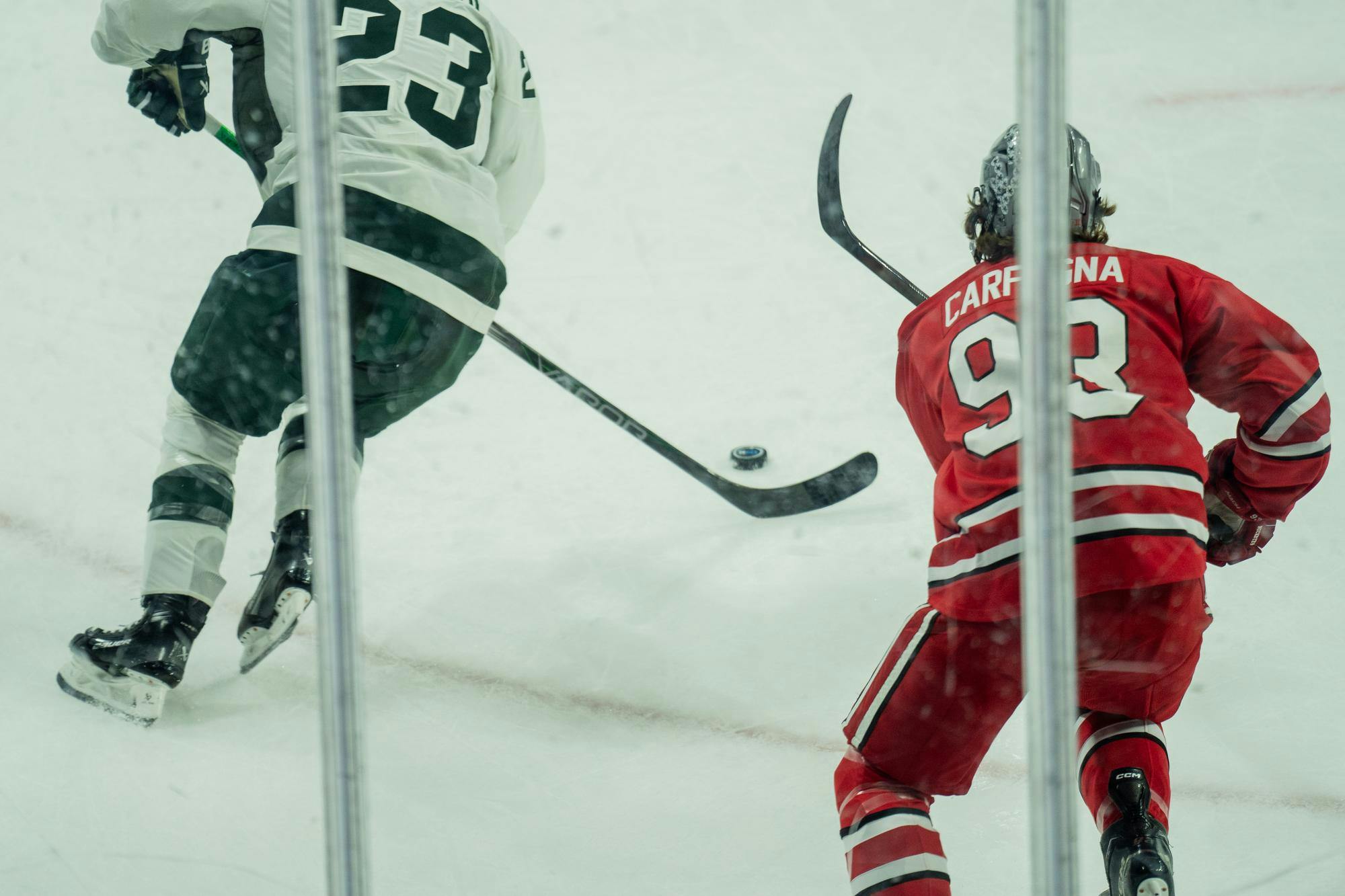 <p>Michigan State freshman forward Shane Vansaghi (23) skates with the puck while Ohio State junior defenseman Damien Carfagna (93) chases him at Munn Ice Arena on Nov. 9, 2024. Michigan State takes the win with 4-1.</p>