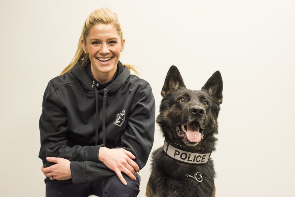 MSUPD officer Kim Parviainen poses for a portrait with her K-9, Bane, on Feb. 8, 2017 at the East Lansing Police Department K-9 training facility in Lansing, Mich. Bane is a dual purpose dog and he specializes in explosives and patrol work.