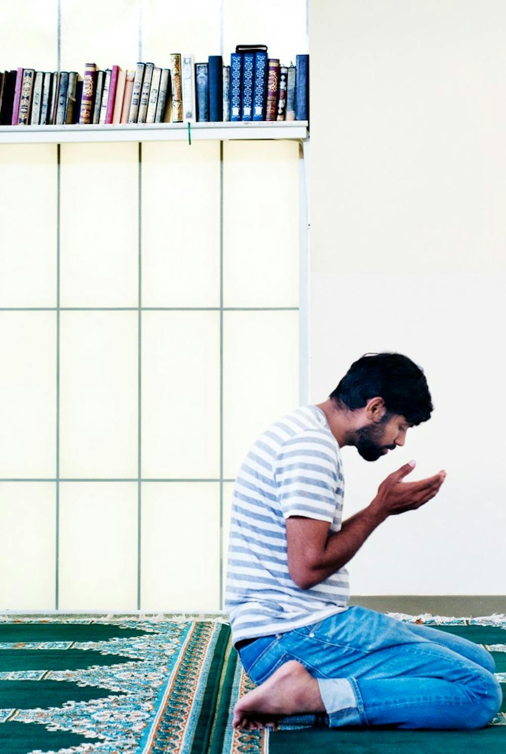 	<p>Chemical engineering graduate student Abu Hassan silently prays Monday afternoon at the Islamic Society of Greater Lansing. Monday marked the start of the Ramadan, a month long period of spirituality and fasting during daylight.</p>