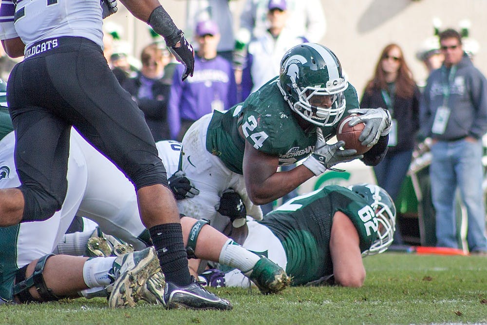 	<p>Junior running back Le&#8217;Veon Bell falls inches short of the end zone on Saturday, Nov. 17, 2012, at Spartan Stadium. The Spartans lost to Northwestern, 23-20. Julia Nagy/The State News</p>