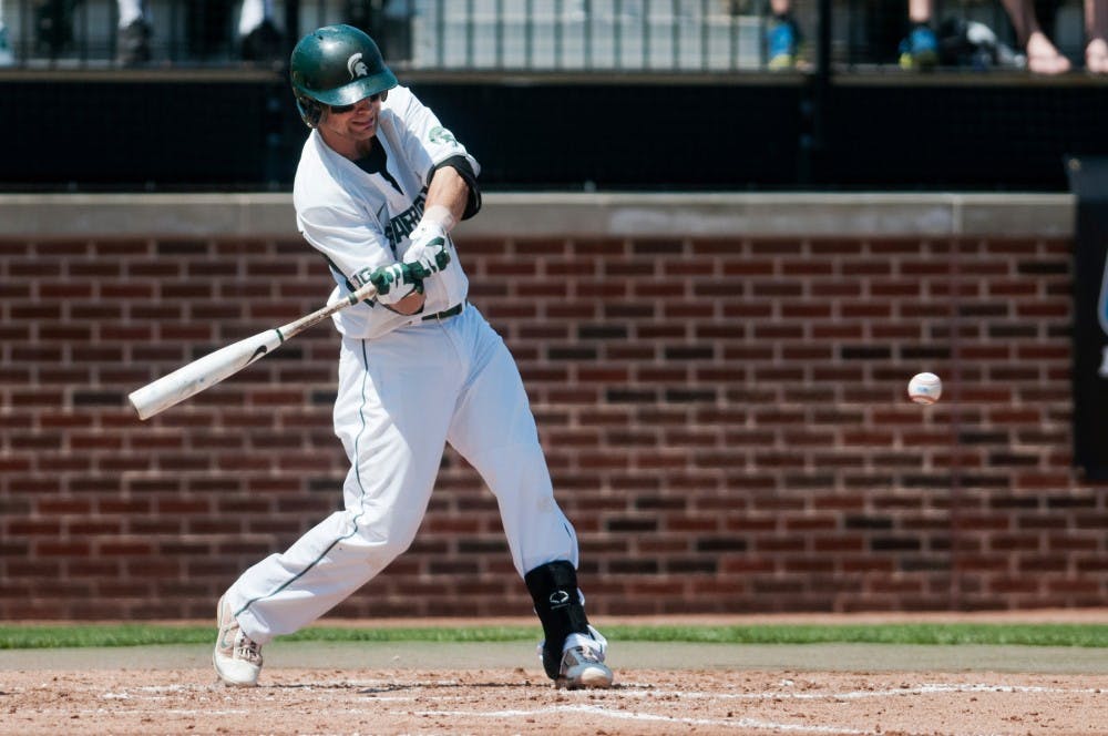 Senior shortstop Justin Scanlon hits the ball during the game against Penn State on May 19, 2012 at McLane Baseball Stadium at Old College Field. The Spartans beat Penn State 9-2. Julia Nagy/The State News