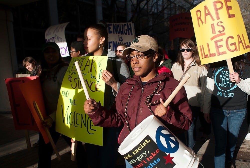 	<p>Biomedical laboratory diagnostic senior Brittany Bennett walks with other students as she hits a makeshift drum during the Take Back the Night march past Kellogg Center Tuesday. The protest called for safer streets and ending domestic violence and sexual assault. Justin Wan/The State News</p>