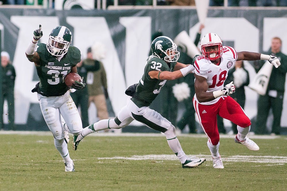 Junior cornerback Darqueze Dennard runs up the field after catching an interception during the game against Nebraska on Nov. 3, 2012, at Spartan Stadium. Dennard caught two interceptions for the Spartans but the Cornhuskers still won 28-24. Natalie Kolb/The State News