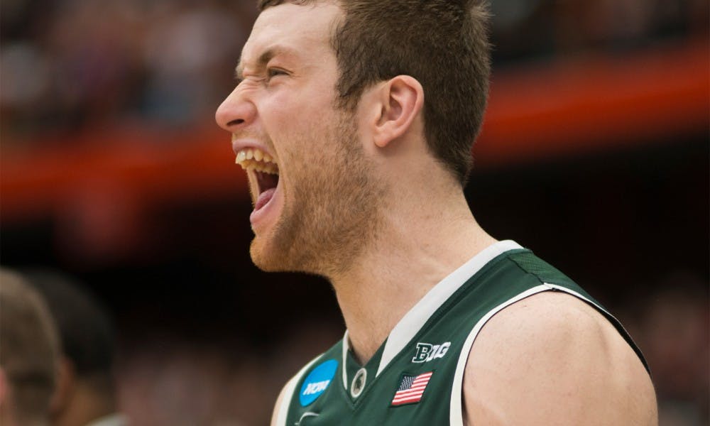 Junior forward Matt Costello cheers after a scored basket March 29, 2015, during the East Regional round of the NCAA Tournament in the Elite Eight against Louisville at the Carrier Dome in Syracuse, New York. The Spartans defeated the Cardinals in overtime, 76-70. Erin Hampton/The State News