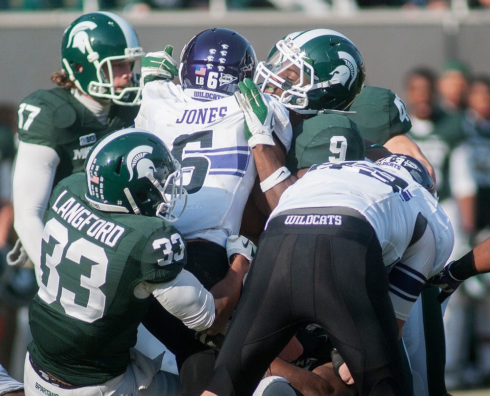 	<p>Wide receiver Tony Jones gets overwhelmed by the Spartans&#8217; defense on Saturday, Nov. 17, 2012, at Spartan Stadium. The Spartan&#8217;s fell to the Northwestern Wildcats 23-20. James Ristau/The State News</p>