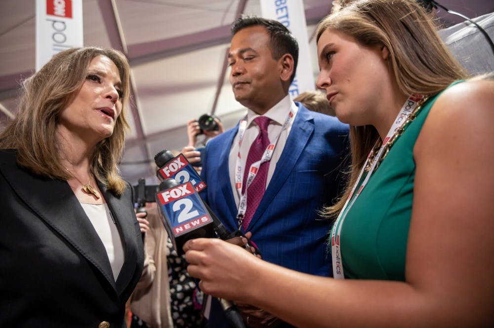 Author Marianne Williamson (left) speaks to Fox 2 Detroit's Roop Raj (center) and Jessica Dupnack (right) after the first night of CNN's Democratic Debates at Detroit's Fox Theater on July 30, 2019.