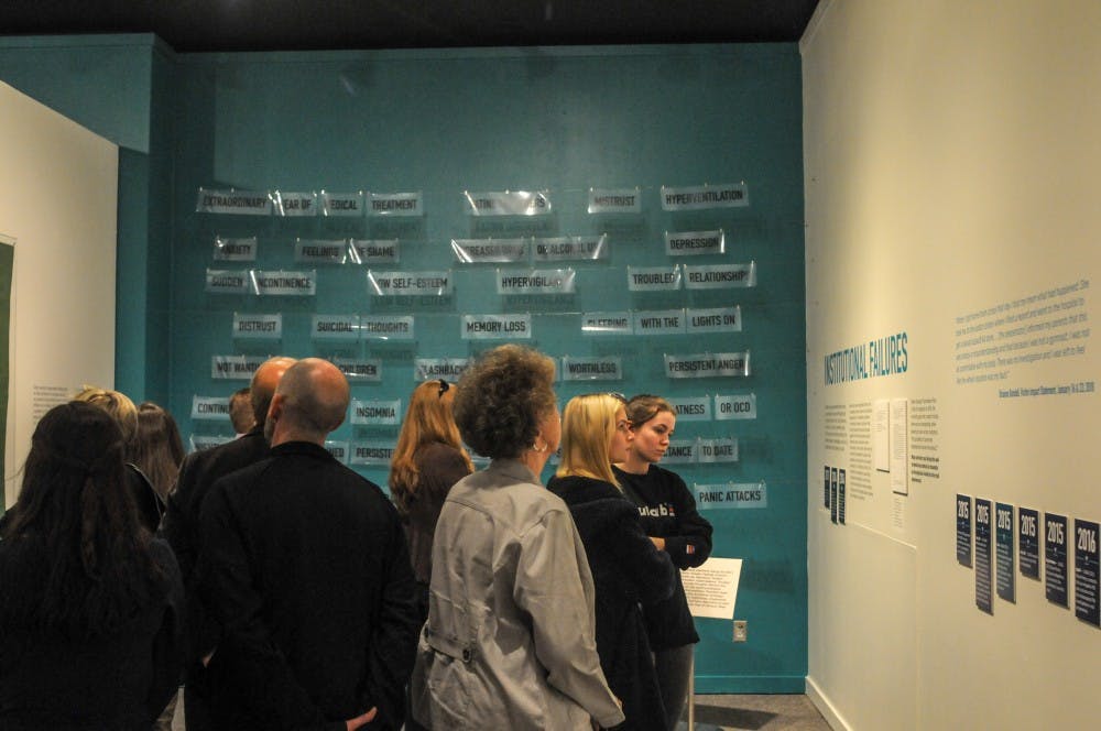 People view the exhibit during the Finding Our Voice: Sister Survivors Speak Exhibition Opening Ceremony at the MSU Museum on April 16, 2019.