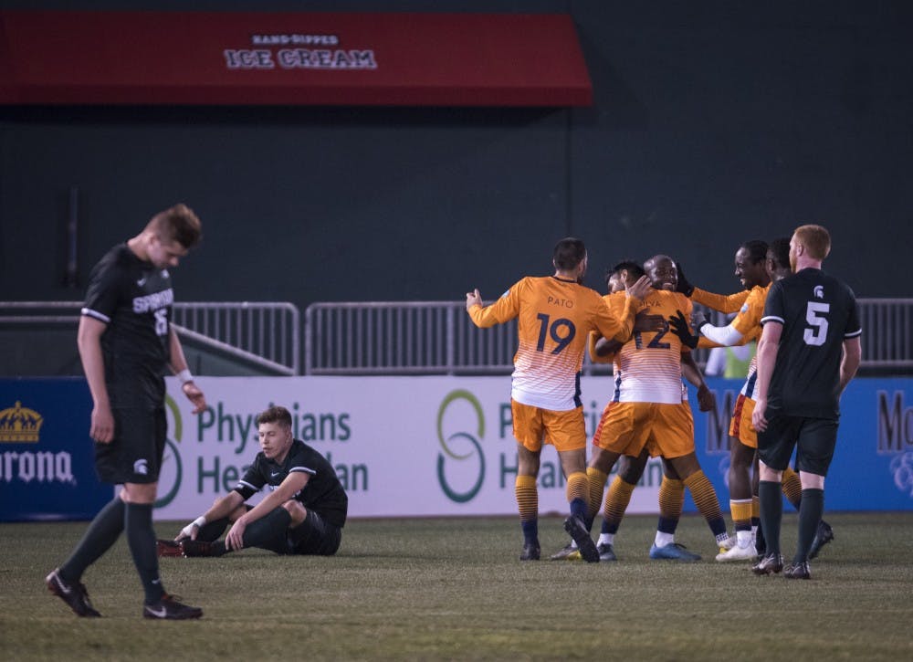 Lansing Ignite players celebrate a goal during the second half of the Capital Cup against Michigan State men's soccer team at Cooley Law School Stadium in Lansing on Tuesday, April 16, 2019. Michigan State was defeated by Lansing Ignite, 4-0. (Nic Antaya/The State News)