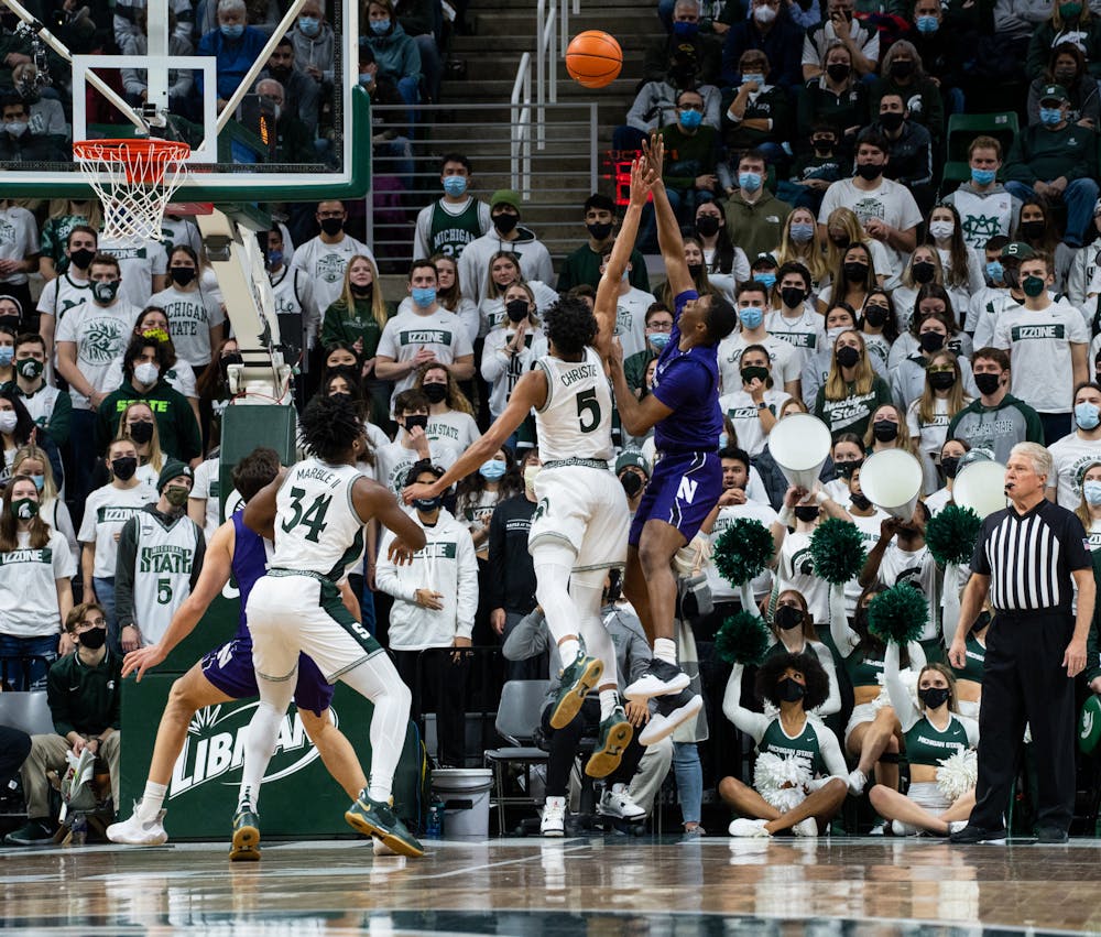 <p>Michigan State&#x27;s freshman guard Max Christie (5) attempts to block Northwestern&#x27;s redshirt junior guard Chase Audige&#x27;s (1) shot during Michigan State&#x27;s loss on Jan. 15, 2022.</p>