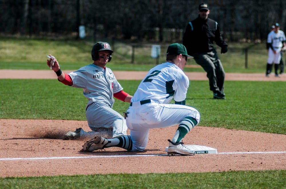 Rutgers outfielder Jawuan Harris slides into third base while freshman infielder Marty Bechina looks to catch during the first game on March 26, 2016 at McLane Stadium. The Spartans defeated the Scarlet Knights, 5-2.