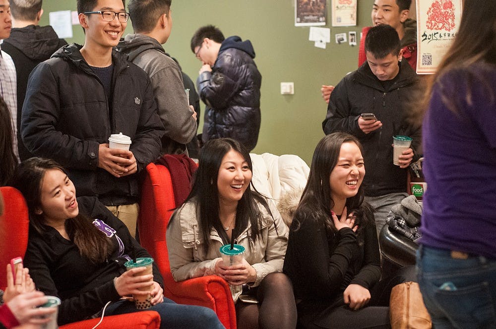 <p>Finance junior Chelsea Chiu, left, and human resource management freshman Tina Lee, center, laugh Jan 23, 2015, at 303 Albert St in East Lansing during the Lambda Phi Epsilon Spring Rush Event. Kennedy Thatch/The State News</p>