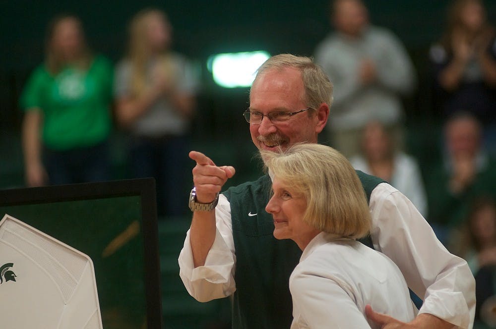 <p>Associate head coach Russ Carney stands next to his wife Sherry Carney as he is acknowledged for his projected retirement Nov. 26, 2014 after the game against Purdue at Jenison Field House. MSU defeated the Boilermakers, 3-0. Dylan Vowell/The State News</p>