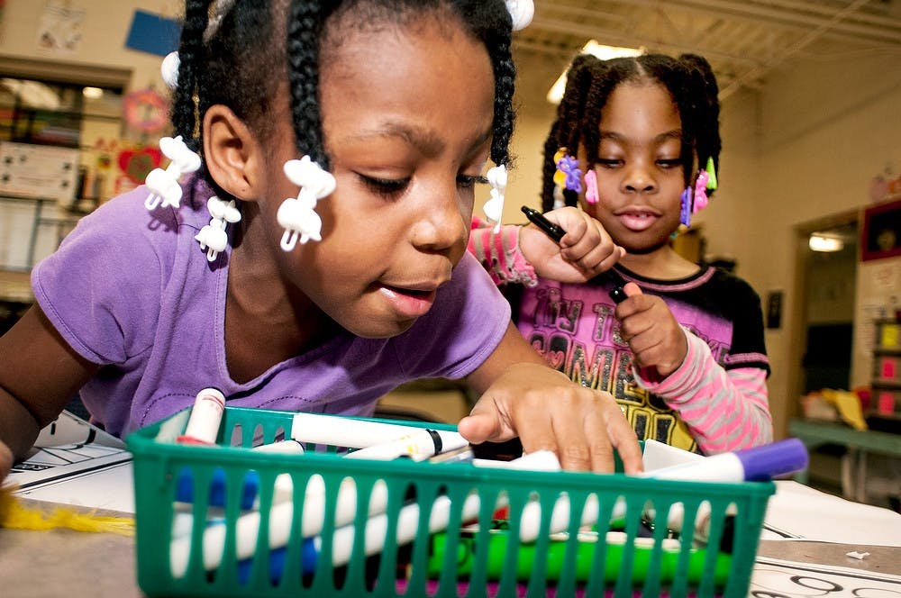 	<p>Lansing resident Samarya Lampkins, 8, left, looks for a marker while Zamaria Hawkins, 6, prepares to color a picture on Saturday, Feb. 23, 2013, at the Boys and Girls Club of Lansing.  Not only is there an arts and crafts room in the building, but also a gym, computer room and junior room.</p>