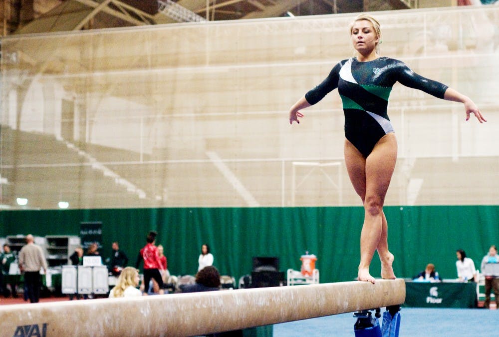 Sophomore Alex Pace on the balance beam Friday night at Jenison Field House. The Michigan State women's gymnastics team defeated Ball State. Derek Berggren/The State News