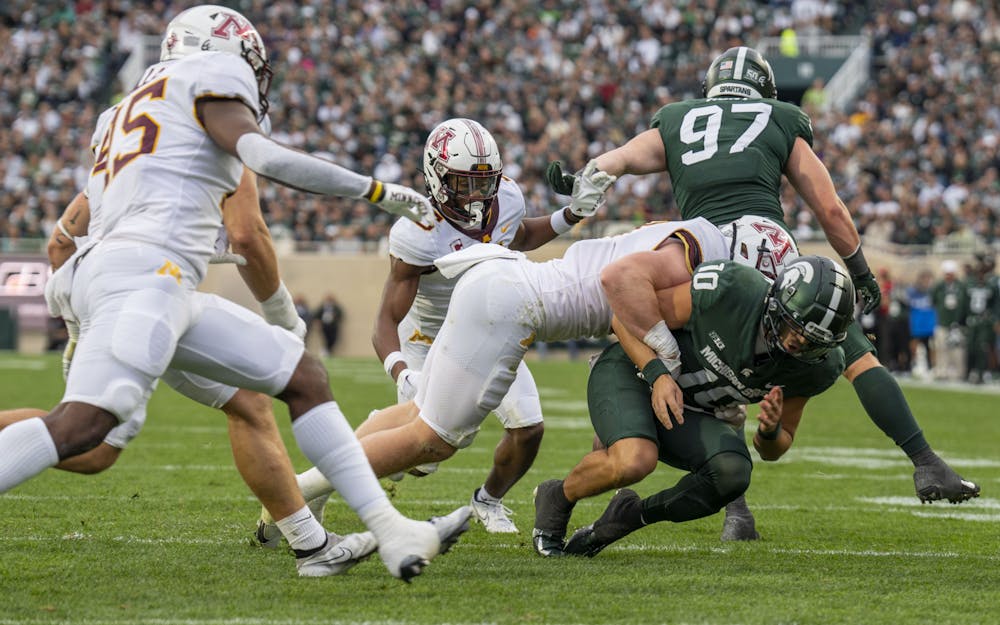 <p>Redshirt junior quarterback Payton Thorne, 10, fumbles in an attempt to break through the Minnesota defense during Michigan State’s match against Minnesota on Saturday, Sept. 24, 2022. The Gophers ultimately beat the Spartans, 34-7.</p>