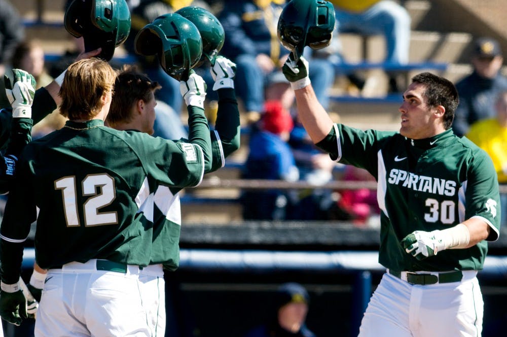 Junior catcher Andy Johnson celebrates with his teammates after hitting a 3-run home run Sunday at Ray Fisher Stadium at Wilpon Baseball Complex in Ann Arbor. Johnson's homer helped the Spartans defeat Michigan, 5-4. Matt Radick/The State News