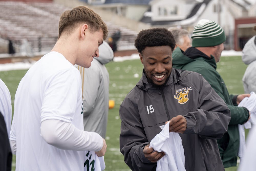 <p>Former MSU player Will Perkins exchanges jerseys before the start of the exhibition game at Keyworth Stadium, on Feb. 25, 2023.</p>