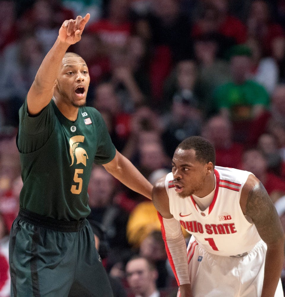 	<p>Junior forward Adreian Payne yells instructions to his team as Ohio State&#8217;s forward Deshaun Thomas watches during the semifinal round of the Big Ten Tournament against Ohio State on March 16, 2013, at United Center in Chicago, Ill. The Buckeyes beat the Spartans, 61-58. Natalie Kolb/The State News</p>