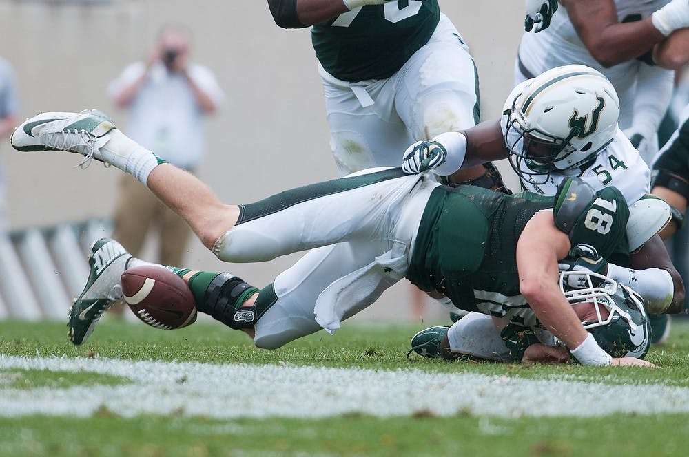 	<p>South Florida defensive end Julius Forte tackles quarterback sophomore Connor Cook causing a fumbled ball Sept. 7, 2013, at Spartan Stadium. University of South Florida recovered the ball. Julia Nagy/The State News</p>