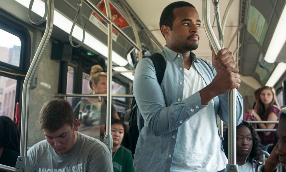 <p>Economics sophomore David Nelson waits for a seat to open up on Sept. 8, 2015, on the 31 CATA bus. The bus makes stops all around the north side of campus and on Grand River Ave. Catherine Ferland/The State News</p>