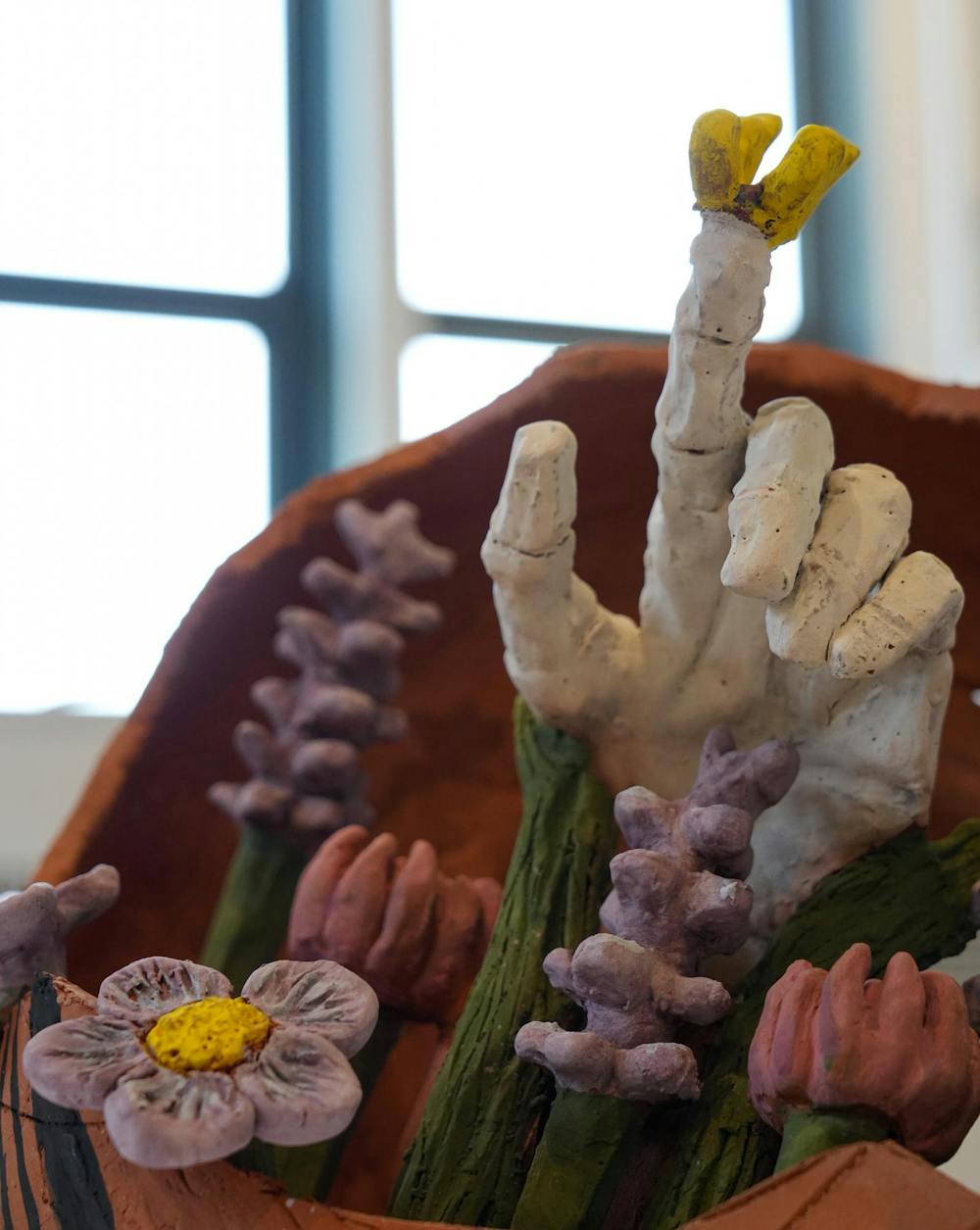 <p>A clay hand with a butterfly on its finger protrudes from the center of a statue being displayed in the Lasting Impressions Art Gallery in the MSU Union in East Lansing, Mich., on Tuesday, Sept. 8, 2026.</p>