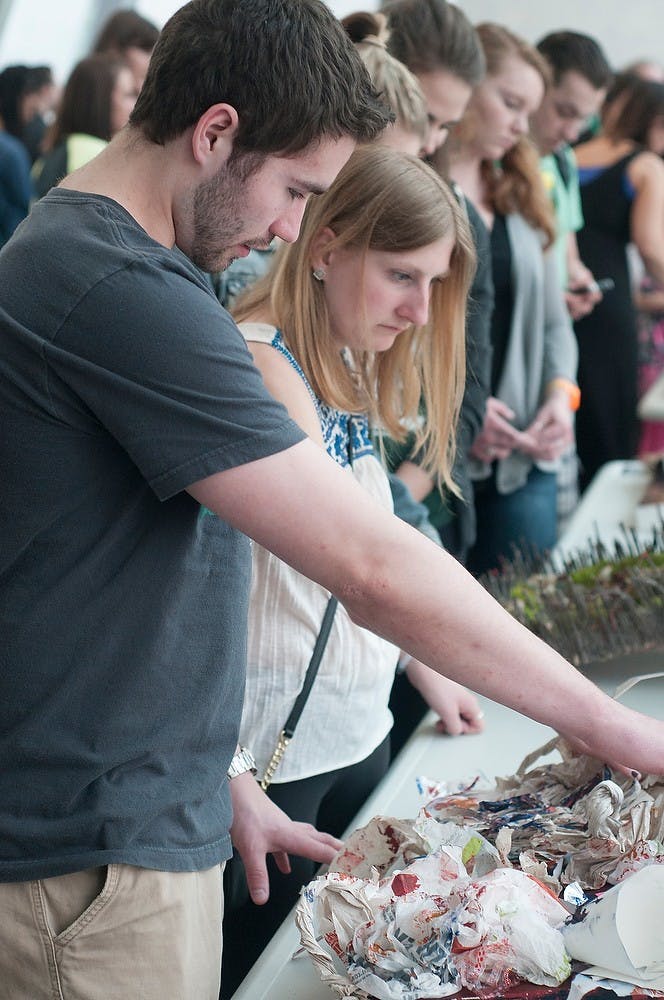 <p>Human biology senior Kyle Muchez and social work junior Samantha Kiriazis view the exhibitions April 14, 2015, during the Exceptions: Accessible Art show at the Eli and Edythe Broad Art Museum. The exhibition was interactive and hands on, showcasing student creativity. Alice Kole/The State News</p>