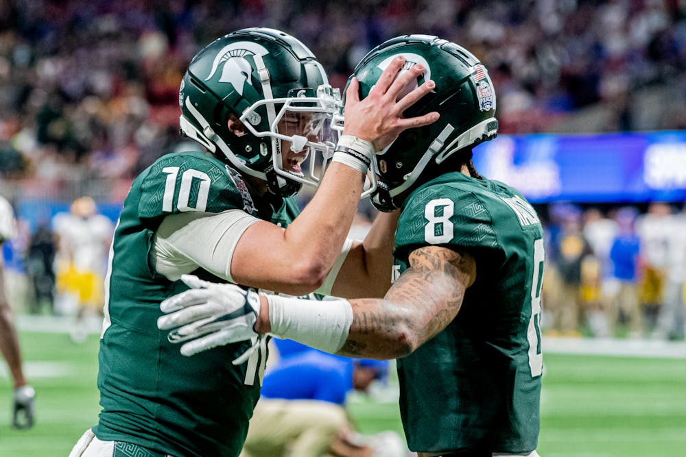 <p>Redshirt sophomore quarterback Payton Thorne and redshirt junior wide receiver Jalen Nailor celebrate a two-point conversion during the Spartans&#x27; 31-21 victory against Pitt in the Chick-Fil-A Peach Bowl on Dec. 30, 2021. The Spartans scored 21 unanswered points in the fourth quarter.</p>