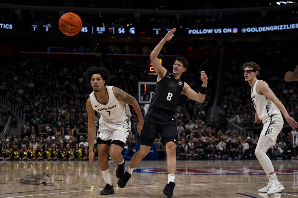 <p>Michigan State senior forward Frankie Fidler (8) passes the ball while Oakland junior guard/forward Isaiah Jones (7) guards him at the Little Caesars Arena in Detroit on Dec. 17, 2024. The Spartans defeated the Golden Grizzlies 77-58.</p>