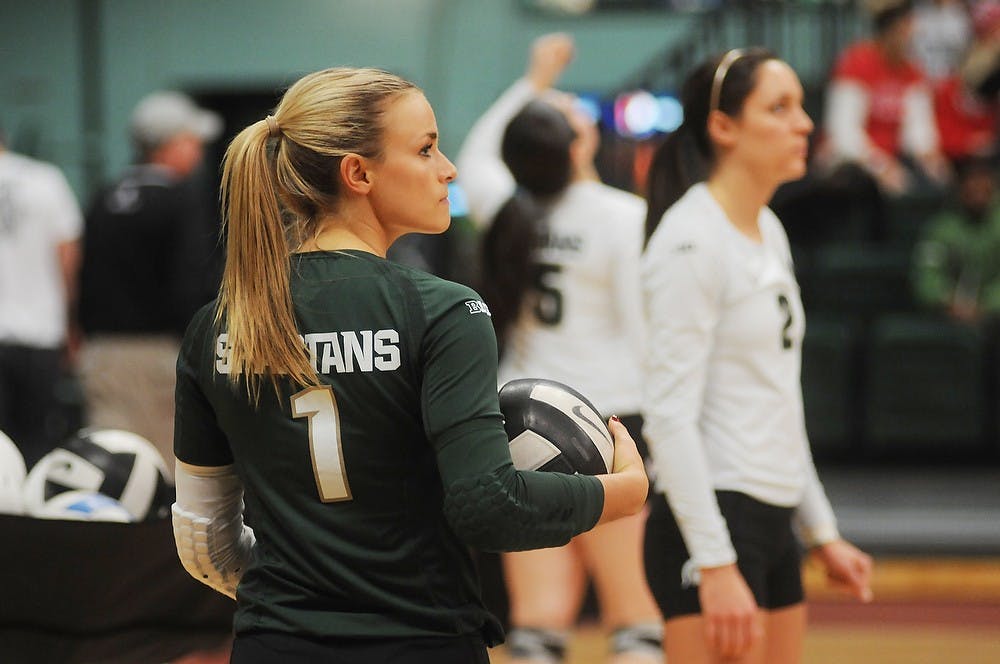 <p>Senior libero Kori Moster warms up Nov. 22, 2014, before the game against Rutgers at Jenison Field House. The Spartans defeated the Scarlet Knights, 3-0. Dylan Vowell/The State News</p>