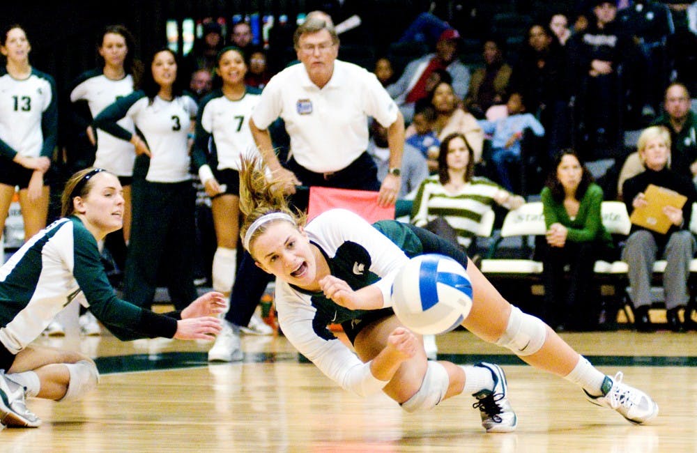 Freshman defensive specialist and libero Kori Moster falls to the floor after attempting to dig the volleyball. The Spartans fell against the Boilermakers, 3-1, Saturday night at Jenison Field House. Justin Wan/The State News