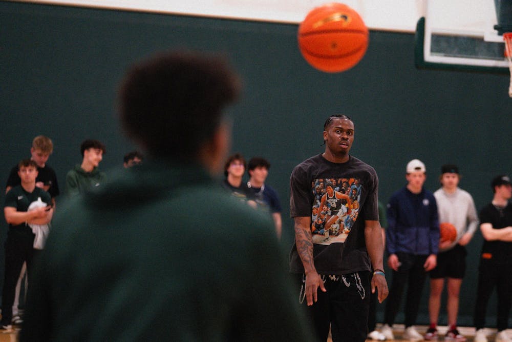 Michigan State sophomore forward Coen Carr passes the ball to teammate sophomore guard Jeremy Fears Jr. in front of students at IM East on April 16, 2025. The men's basketball team showed off their skills during pickup runs for students to watch.