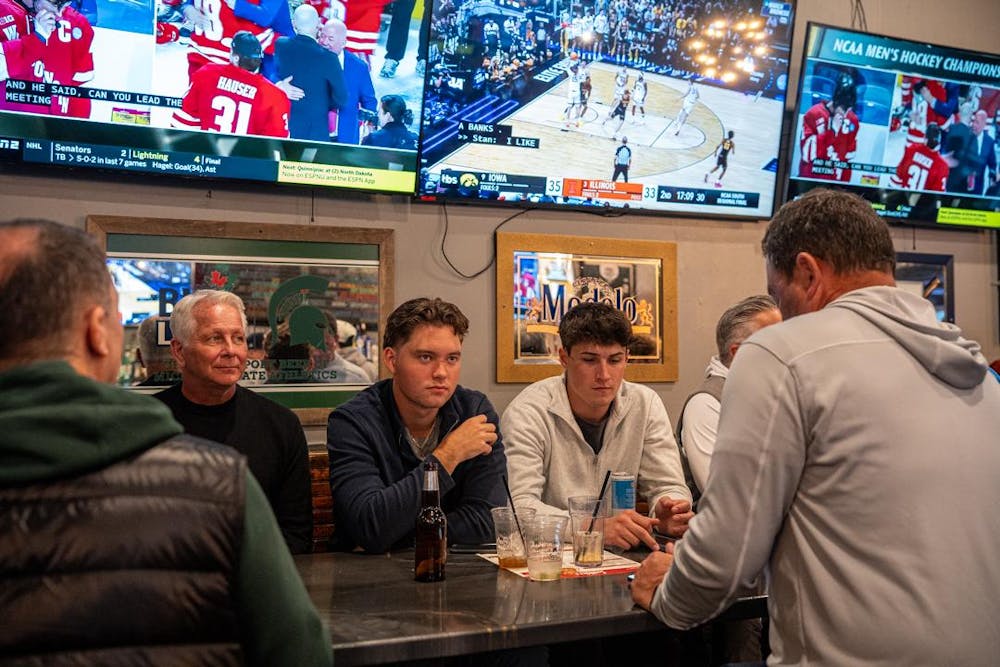 <p>Spectators at Lou and Harry's Bar and Grill in East Lansing, MI watch the Spartans face off against the Wisconsin Badgers on March 28, 2026. The Spartans fell to the Badgers in overtime, 4-3.</p>